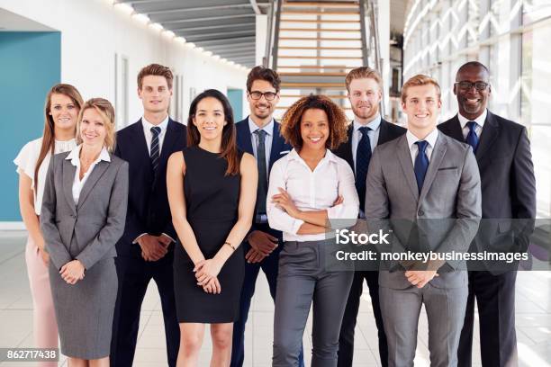 Office Workers In A Modern Lobby Group Portrait Stock Photo - Download Image Now - Professional Occupation, Young Adult, Multiracial Group