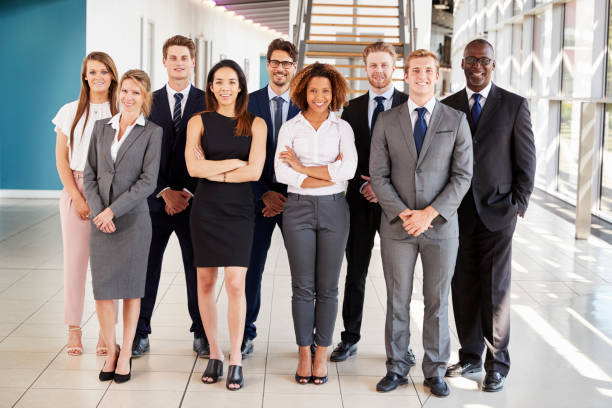 istock Office workers in a modern lobby, full length group portrait 862717460