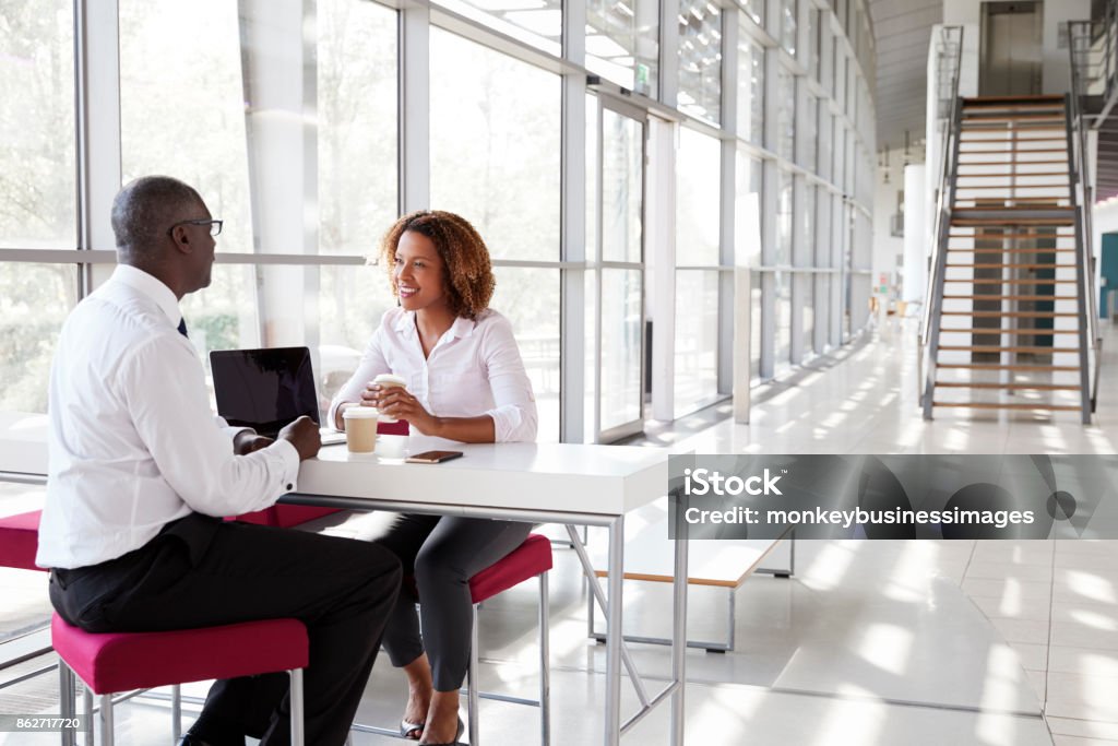Businesswoman and businessman at a meeting, talking Business Meeting Stock Photo