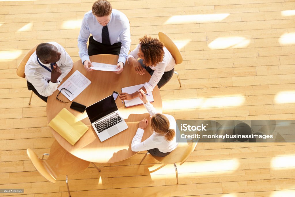 Four business colleagues in a team meeting, aerial view Business Meeting Stock Photo