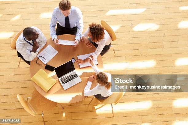 Four Business Colleagues In A Team Meeting Aerial View Stock Photo - Download Image Now