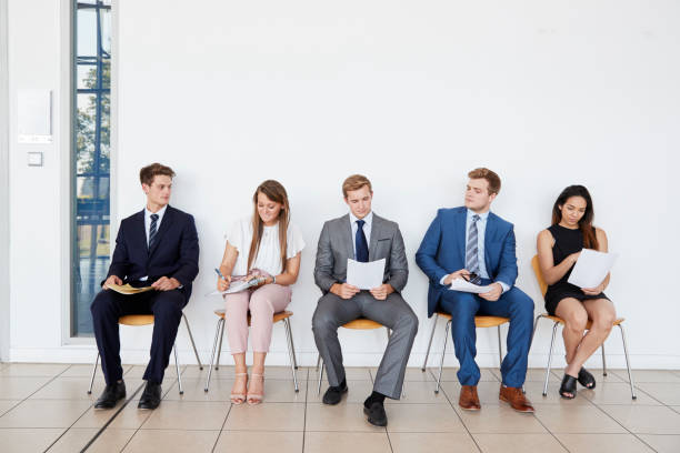 istock Candidates waiting for job interviews, full length, front 862718158