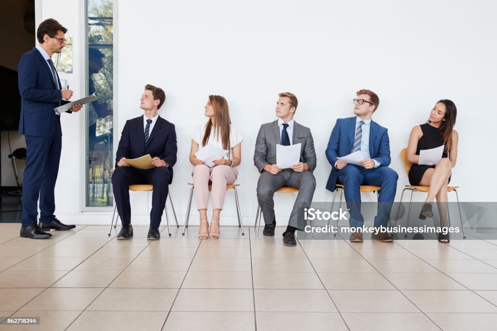 Recruiter and people waiting for job interviews, full length Occupation Stock Photo
