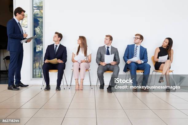 Recruiter And People Waiting For Job Interviews Full Length Stock Photo - Download Image Now