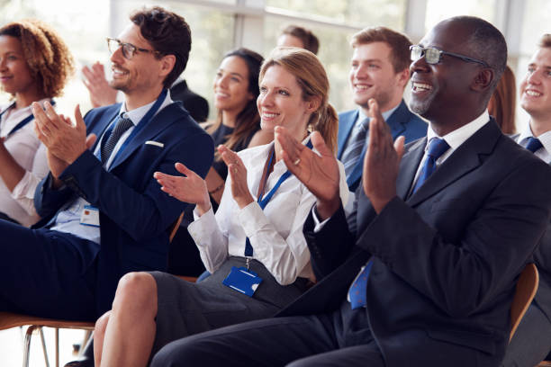 istock Smiling audience applauding at a business seminar 862718360