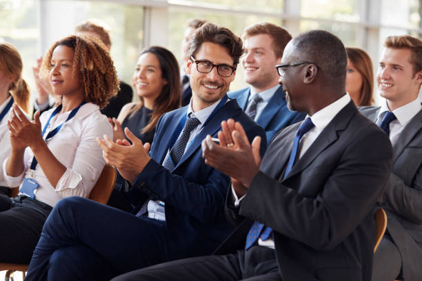 istock Audience clapping at business seminar, looking at each other 862718392