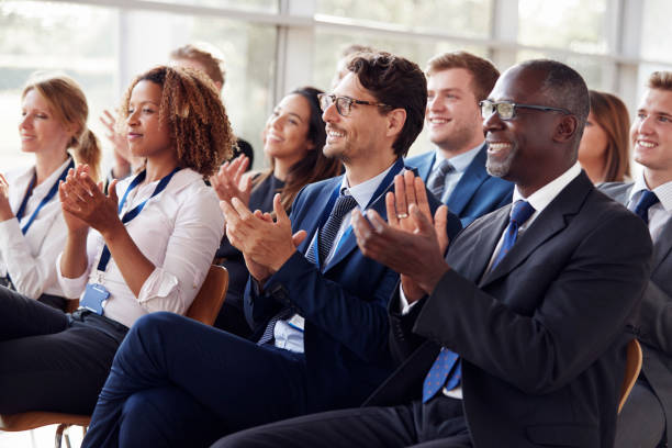 istock Smiling audience applauding at a business seminar 862718922