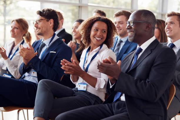 smiling audience applauding at a business seminar - business conference imagens e fotografias de stock