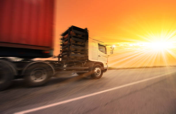 truck running on the road with the sun background , transportation concept