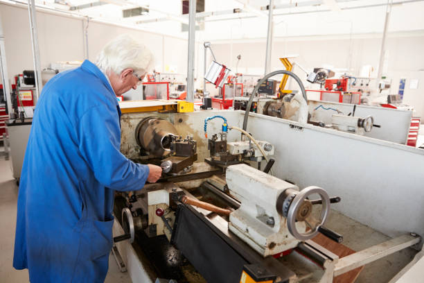 istock Senior engineer working in a factory, back view 862720852