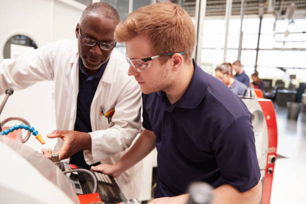 istock Engineer giving guidance to apprentice in factory, close up 862721364