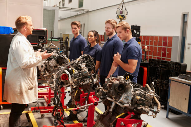 istock Apprentices studying car engines with a mechanic 862721468