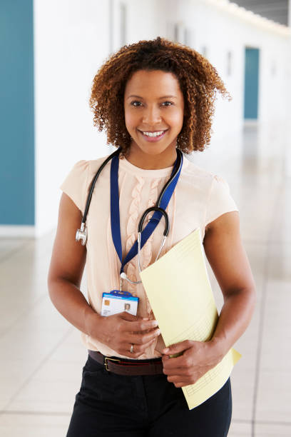 istock Smiling young female doctor with stethoscope and notes 862721786
