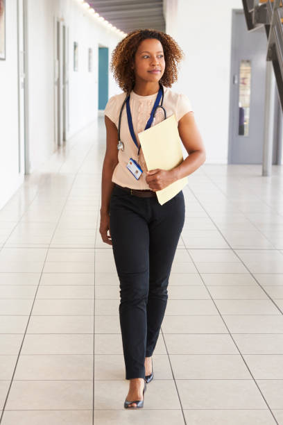 istock A young doctor with stethoscope, walking in modern lobby 862721854