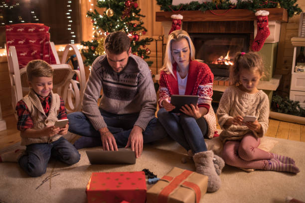 istock Young family using wireless technology on Christmas eve at home. 862722090