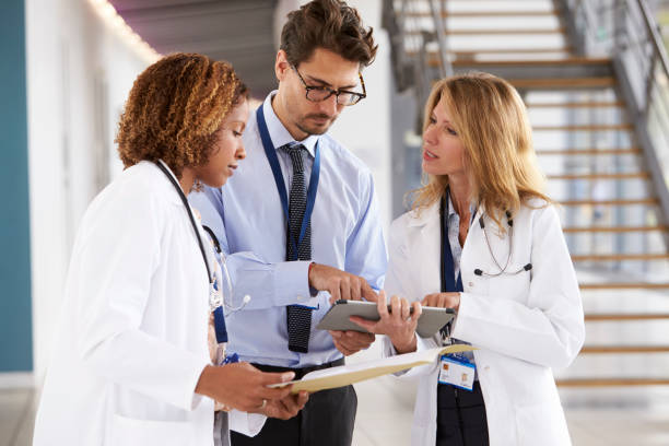 istock Three young male and female doctors consulting 862723060