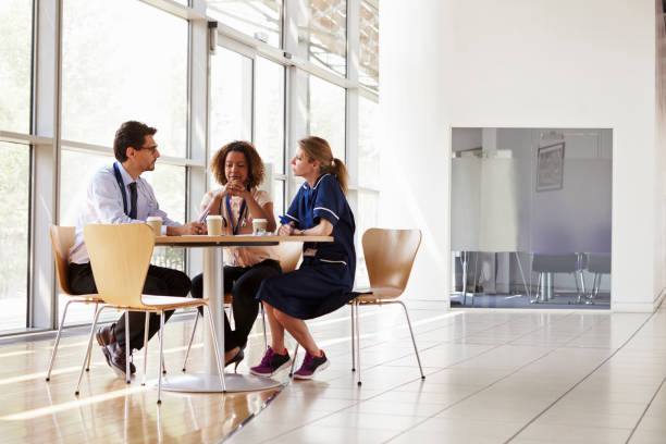 istock Three senior healthcare workers in a meeting, low angle 862724582