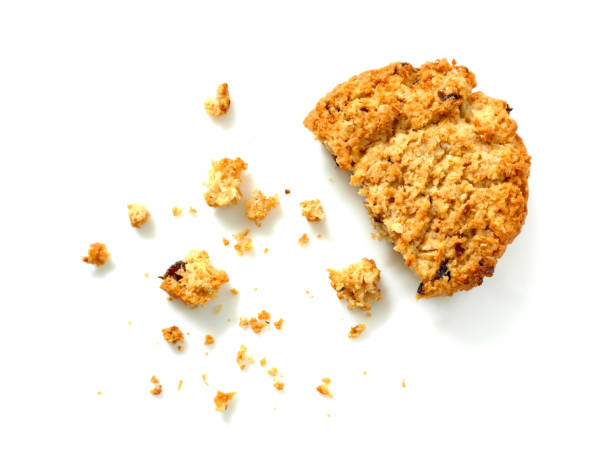 Oatmeal cookie with crumbs Oatmeal cookie with crumbs isolated on white background. Top view. crumb stock pictures, royalty-free photos & images
