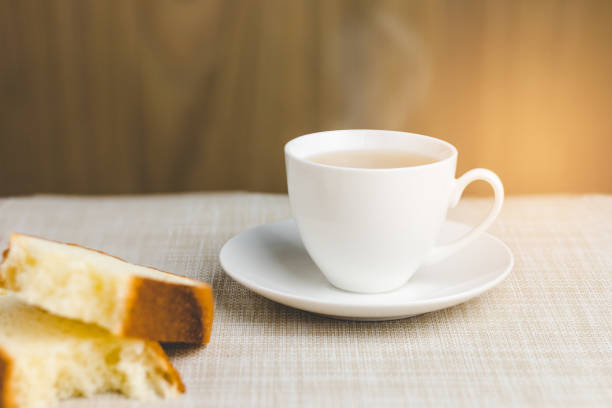 istock Cup of tea with bread for breakfast on wooden background 862729478
