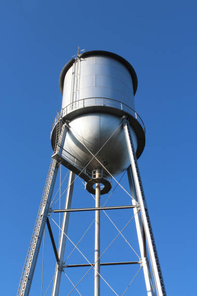 istock Tall old style water tower against a deep blue sky 862736608
