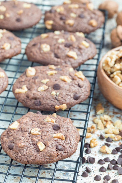 istock Homemade chocolate cookies with walnuts and chocolate chips on cooling rack, vertical 862739144