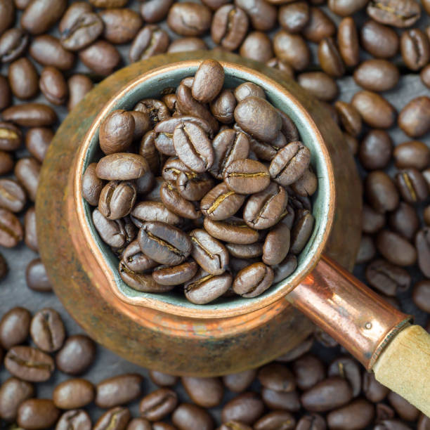 istock Fragrant coffee beans in a copper cezve, top view, close up, square format 862739158