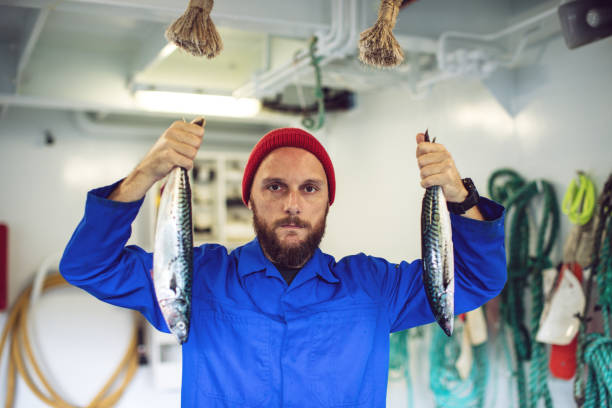 istock Fisherman with fresh fish on the fishing boat deck 862740836