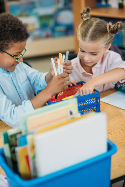 istock kids choosing supplies in box 862741730