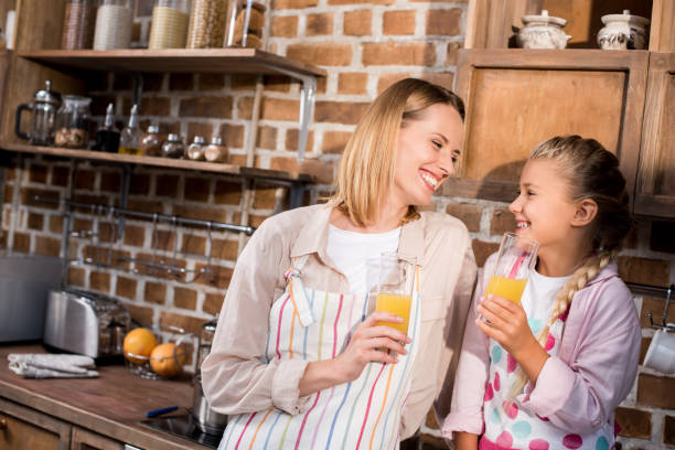 istock mother and daughter with juice 862750676