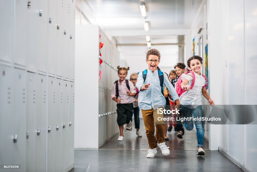 pupils running through school corridor cute funny pupils running through school corridor Back to School Stock Photo