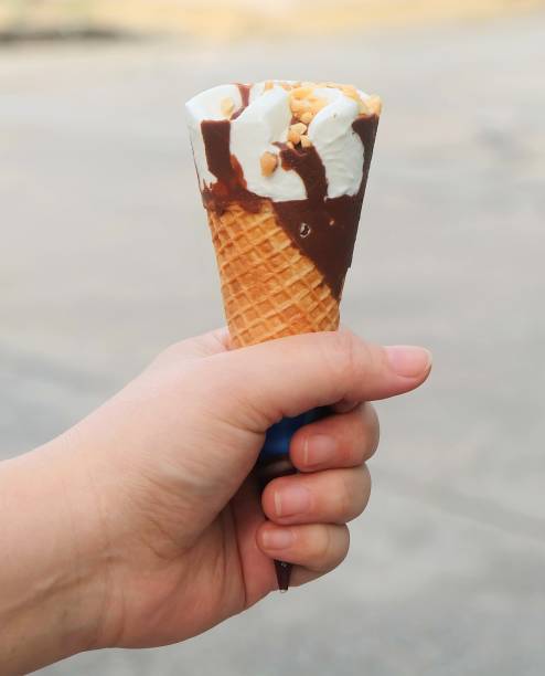 istock Hand Holding Ice Cream Cones with Chocolate 862754622