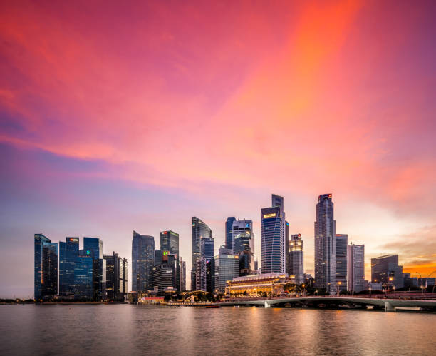 Singapore Skyline at Sunset View of modern skyscrapers in downtown Singapore with a romantic sky. singapore city stock pictures, royalty-free photos & images