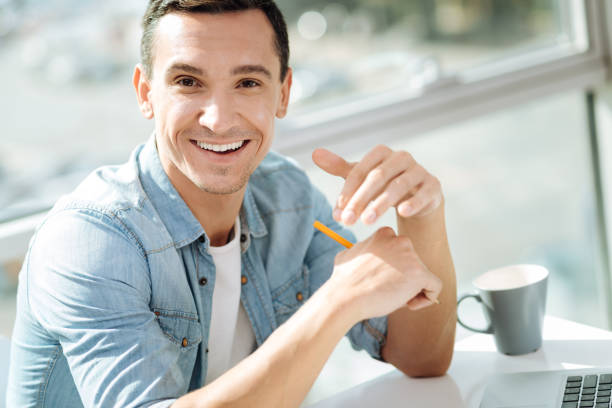istock Cheerful brunette male sitting at his workplace 862763536