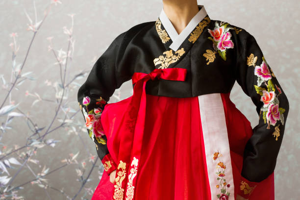 The woman wearing colorful Hanbok, Korean traditional dress in the oriental flower background. Clothing, Dress, Gold Leaf, Silk, Korea, Holiday, Hanbok, Costume, black and red butterfly stock pictures, royalty-free photos & images