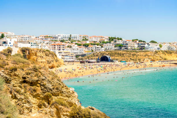 People enjoying ocean and beach in Albufeira, Portugal People enjoying Atlantic Ocean and wide beach in Albufeira, Portugal albufeira photos stock pictures, royalty-free photos & images