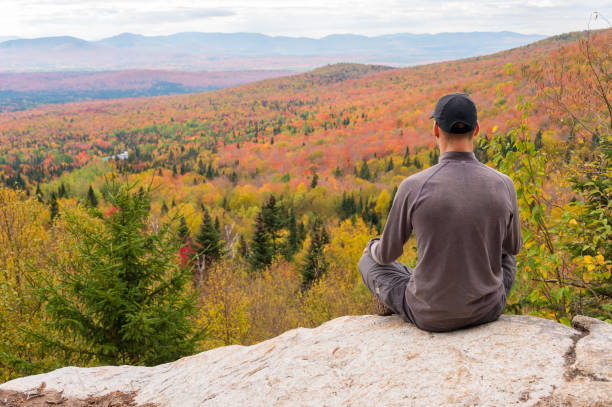 istock Young man standing at panoramic lookout on Megantic Mount in Canada, enjoying autumn colours 862780928