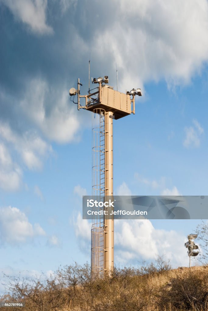 Surveillance Tower on the USA - Mexico Border A surveillance tower guards the USA-Mexico Border between Nogales, Arizona, USA and Nogales, Sonora, Mexico. Arid Climate Stock Photo