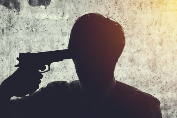 Businessman points gun to his head Businessman points gun to his head, disappointed suicidal man about to commit a suicide. Unemployment and business failure concept. head shoot stock pictures, royalty-free photos & images