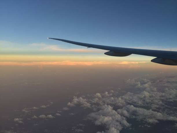 istock Colorful dusk sky horizon from airplane window 862791942