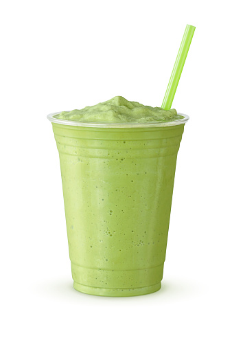 A green tea frappe or milkshake with a straw. This blended drink is made with Japanese matcha powder, ice, sugar, and regular or non-dairy milk in a plastic cup on a white background.