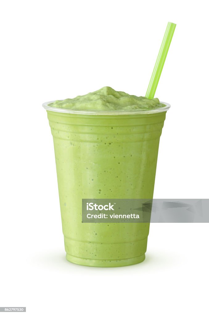 Cold Green Tea Frappe or Milkshake in Plastic Cup with Straw on White Background A green tea frappe or milkshake with a straw. This blended drink is made with Japanese matcha powder, ice, sugar, and regular or non-dairy milk in a plastic cup on a white background. Smoothie Stock Photo
