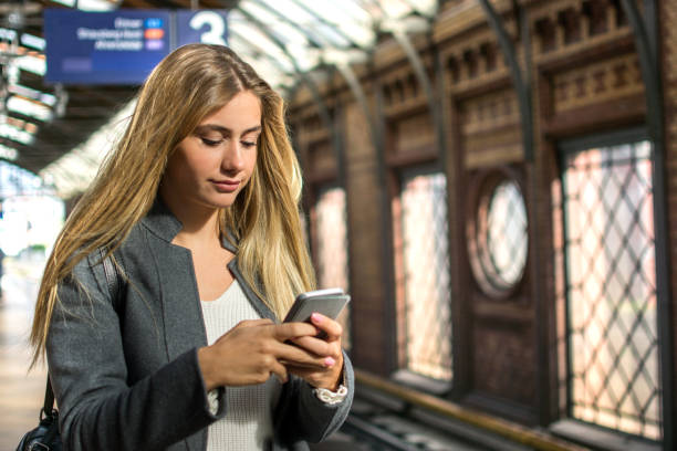 istock Portrait of girl using mobile phone at train station. 862801200