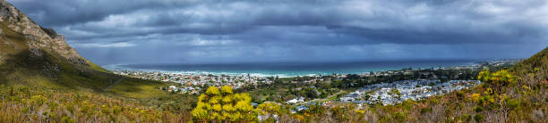 Panoramic view  over the town and the coastline in  Hermanus,South Africa Hermanus is the best land based place to spot the migrating southern right wales during winter and springtime. Picture was taken from the Fernkloof Nature Reserve, famous for its fynbos. hermanus stock pictures, royalty-free photos & images