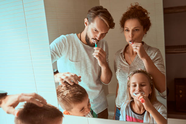 istock young family brushing teeth together 862931292