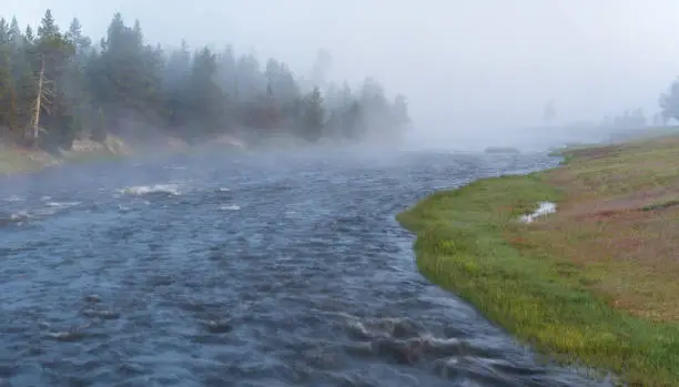 Firehole River in the morning surrounded by fog in Yellowstone National Park, Wyoming