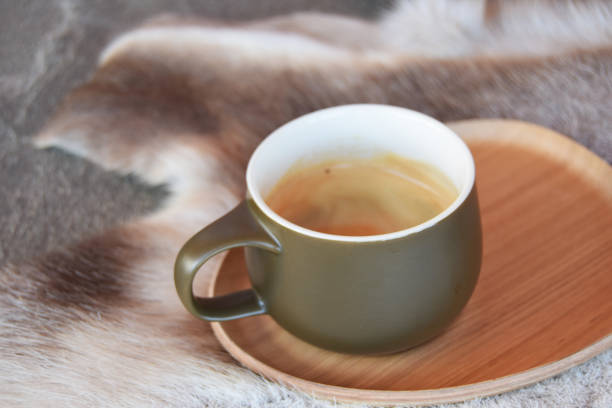 Coffee cup with saucer on reindeer skins stock photo