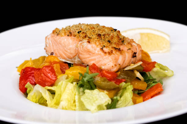 istock Grilled salmon fillet with herb crust on roasted vegetable salad. 863087008