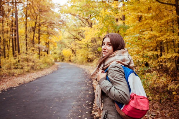 istock Tourist walking through the autumn forest 863095960