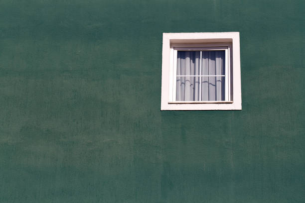 istock White window on an old green stucco wall, Turkey 863096536