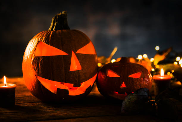 istock Halloween pumpkin head jack lantern with burning candles 863102506